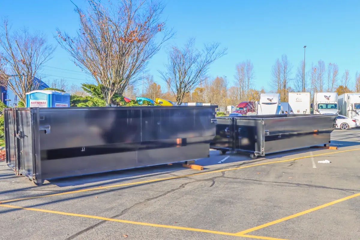 Professional dumpster rental service with roll-off container on residential driveway in Whitfield